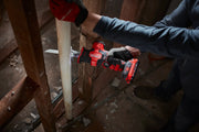 Photo of a person using a Craftsman cordless reciprocating saw, SKU CMCS340B, to cut a white PVC pipe during construction.